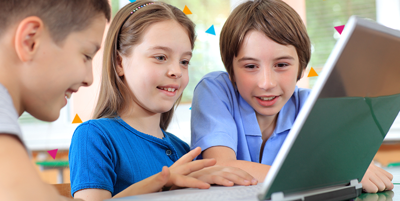 Three happy children using a laptop.